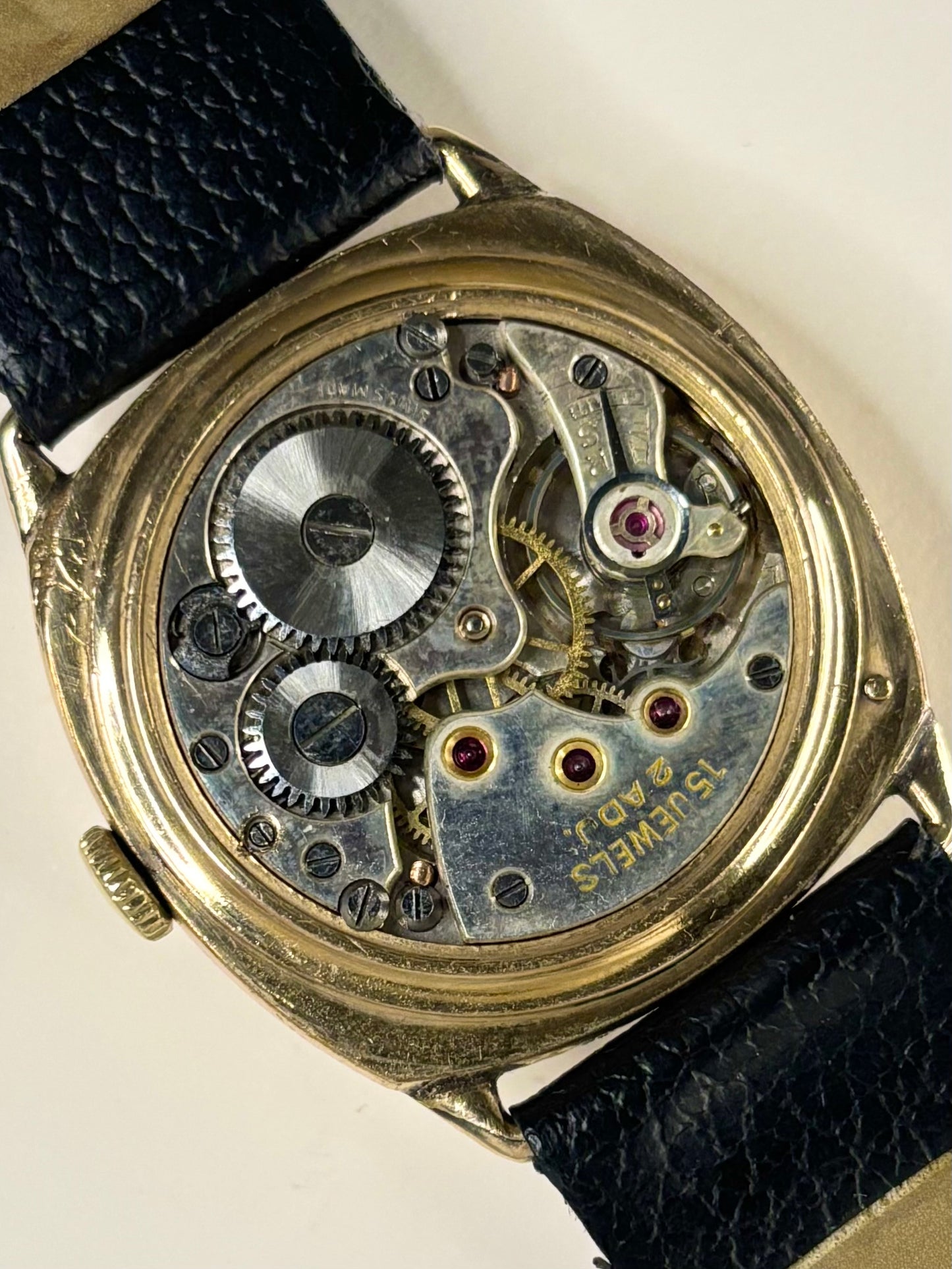 1945 Sackville cushion watch — rolled gold 30mm case with polished caseback and manual wind mechanism