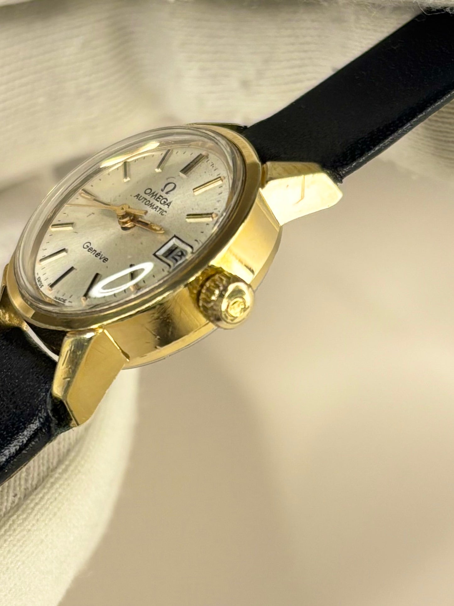 Side view of 1970s Omega ladies Geneve watch showing slim gold-plated profile omega signed crown