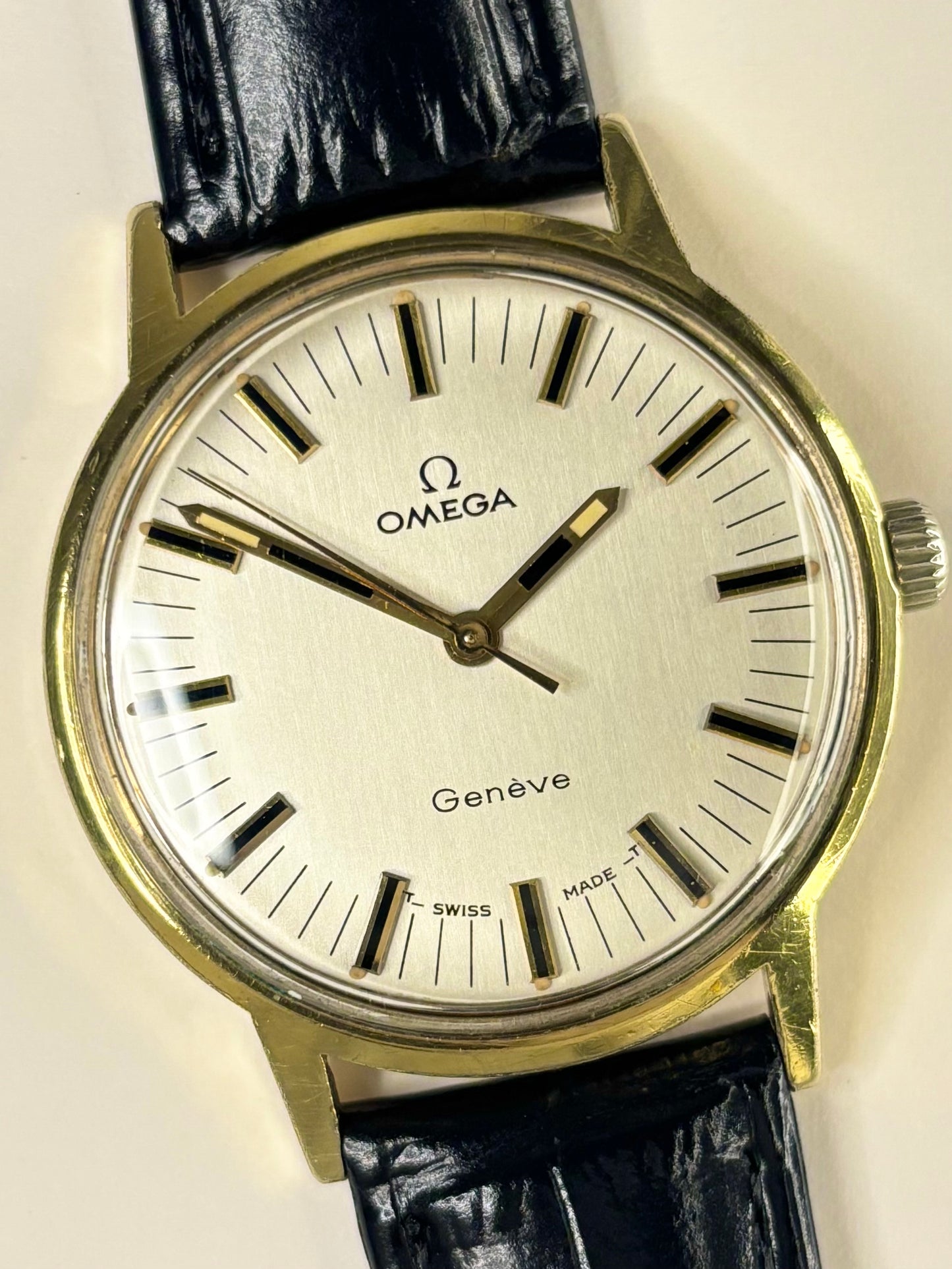 Close-up of Omega Genève vintage manual watch with gold-plated case and original dial, ref. 135.070