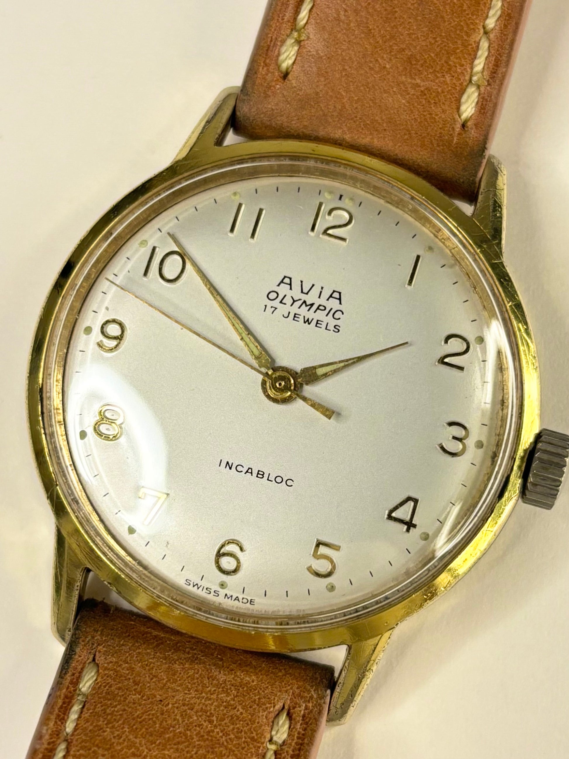 Close up of Avia Olympic 1960s gold dial vintage men’s watch
