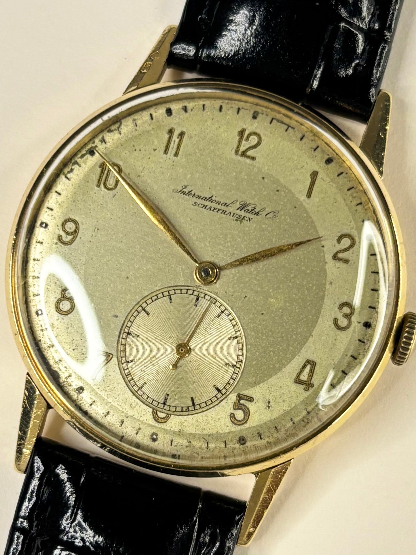 Close up of IWC Schaffhausen 1944 men’s watch dial with patina