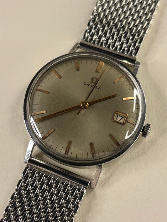 Vintage Omega Ref. 132.012 men’s stainless steel timekeeper showcasing rare olive green dial and 1960s design