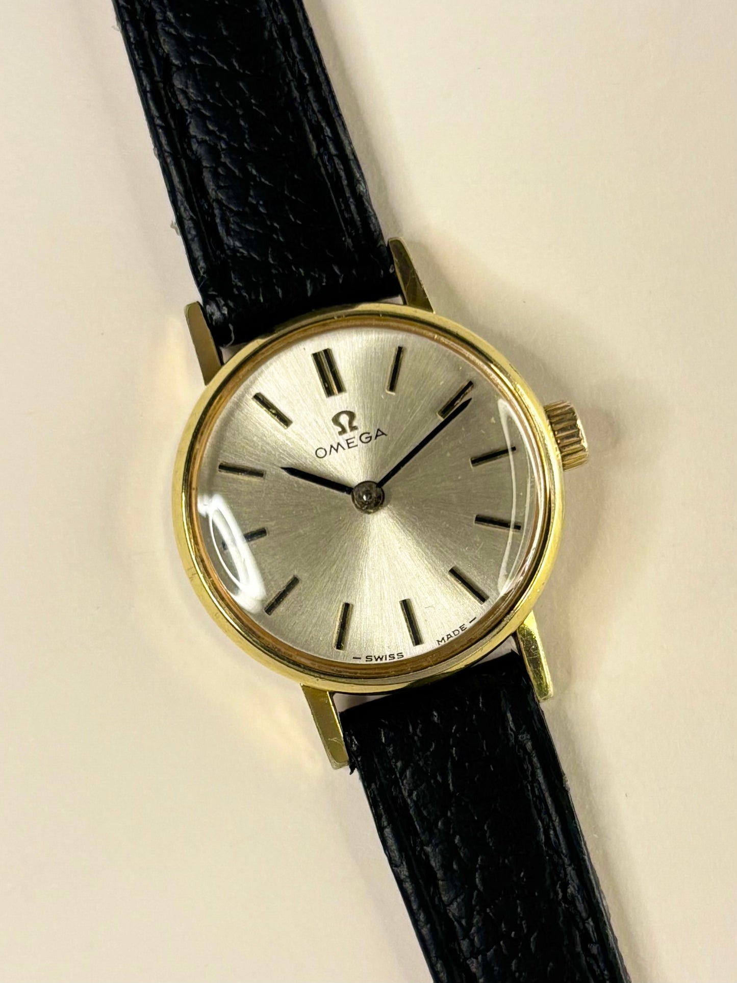 Close-up of Omega ladies vintage manual watch with sunburst dial and gold-plated case, ref. 511.213