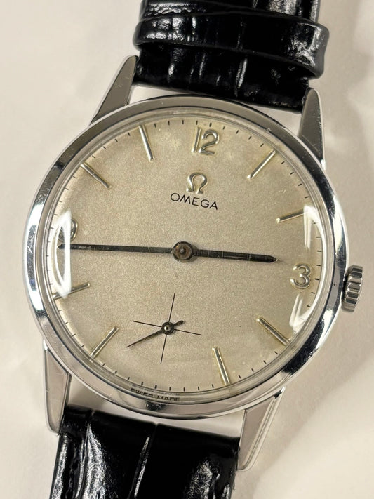 Vintage Omega Ref. 121.001-63 men’s stainless steel timekeeper showcasing elegant 1960s Swiss design