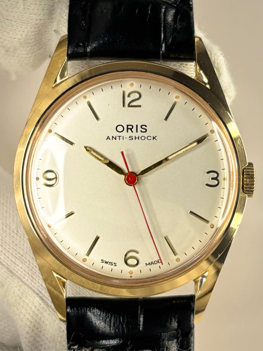 Close-up of Oris vintage manual men’s watch with gold-plated case and classic dial
