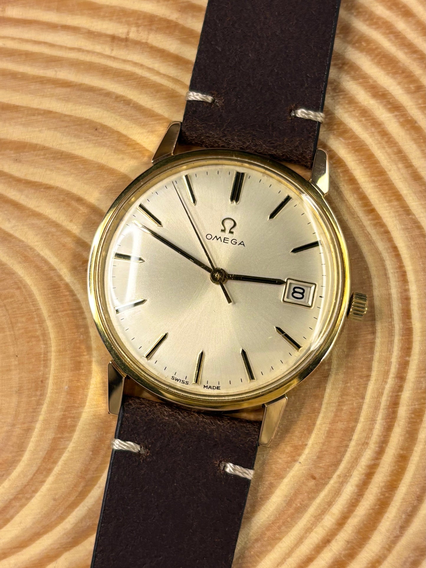 Premium luxury handmade brown Italian calf leather watch strap with stainless steel buckle seen on a vintage omega dress watch