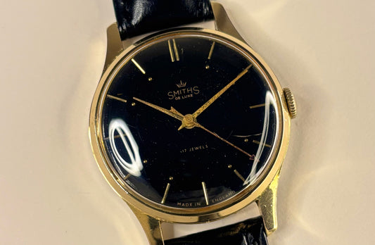 smiths de luxe vintage mens manual gold dress watch with black dial dating to the 1960s 