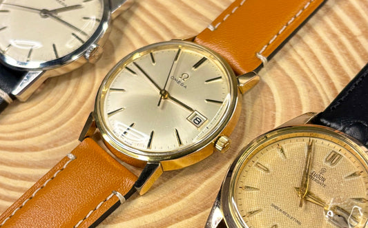 selection of vintage watches, including 2 1960s vintage omegas and one 1950s tudor oyster date with honeycomb dial 