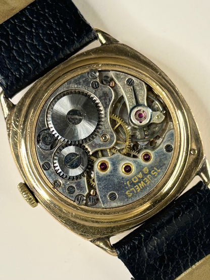1945 Sackville cushion watch — rolled gold 30mm case with polished caseback and manual wind mechanism