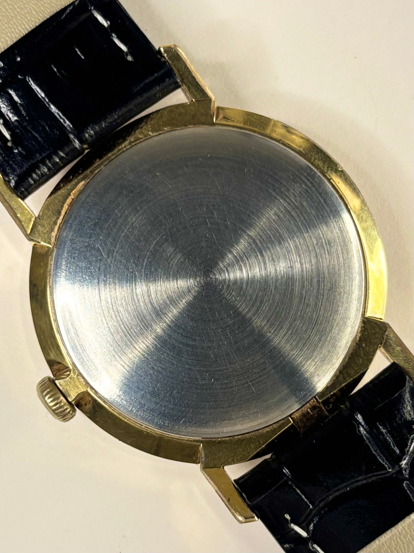 caseback shot of the Rotary manual-wind timepiece focusing on the elegant white sunburst dial, photographed as a beautifully preserved vintage timekeeper.