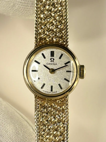 Detailed shot of the Omega ladies 711.5675 timepiece highlighting the smooth dial and rich 9ct gold case, presented as a timeless manual-wind timekeeper.