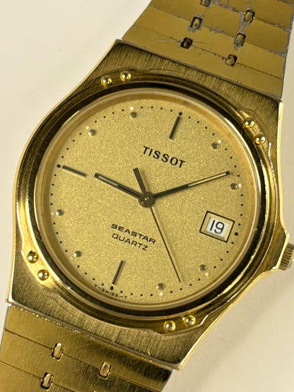 Collectible Tissot 1984 men’s vintage timekeeper featuring gold toned dial, quartz movement and original papers
