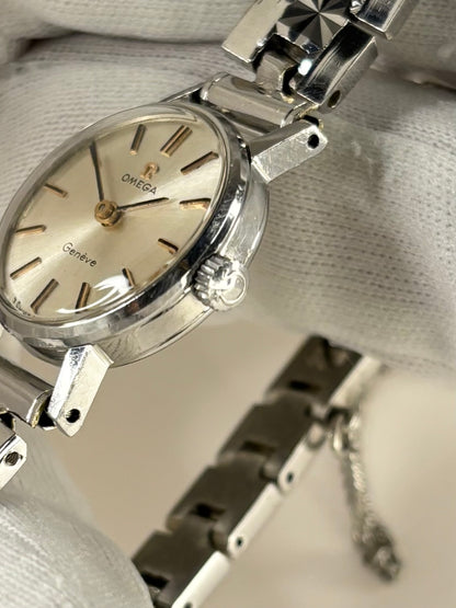 Side profile of Omega ladies vintage 1960s stainless steel timekeeper with slim case design signed omega crown