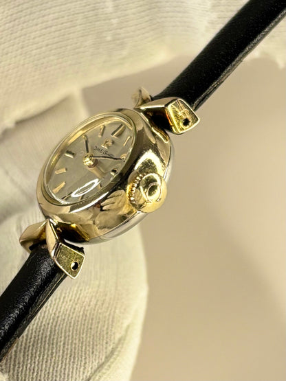 Side profile of Omega ladies Ref. 1973 1970s vintage timekeeper with slim gold plated case styling omega signed crown