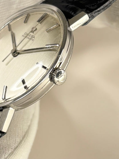 Side profile of Omega Ref. 161.009 1965 men’s vintage dress timekeeper with slim stainless steel case styling omega signed crown