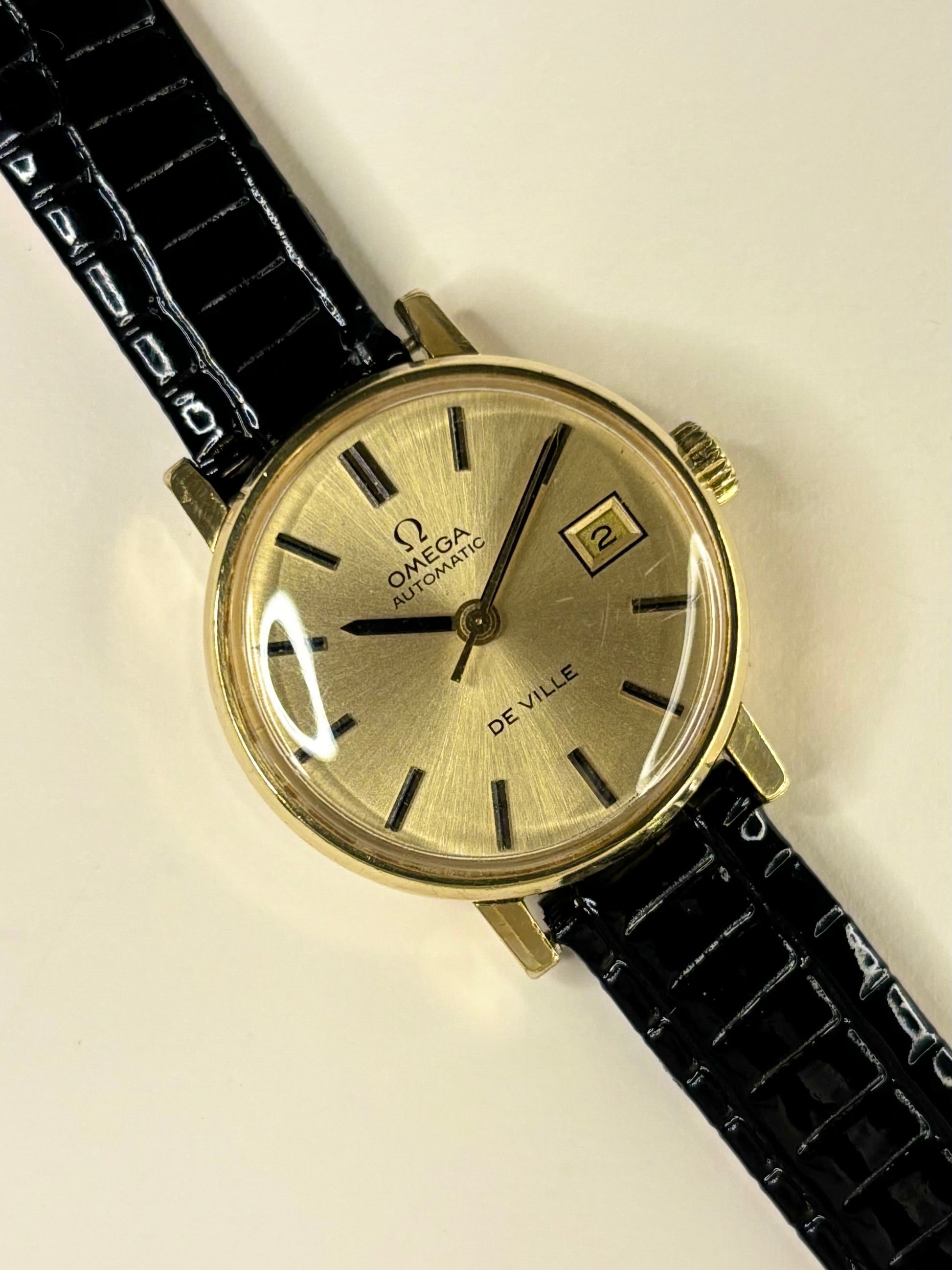 Omega De Ville ladies timepiece model 562.0018 with gold-toned dial and gold-plated case, powered by calibre 684 automatic timekeeper.
