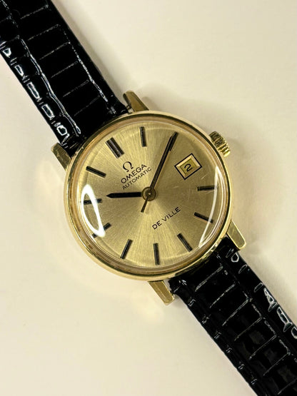 Omega De Ville ladies timepiece model 562.0018 with gold-toned dial and gold-plated case, powered by calibre 684 automatic timekeeper.