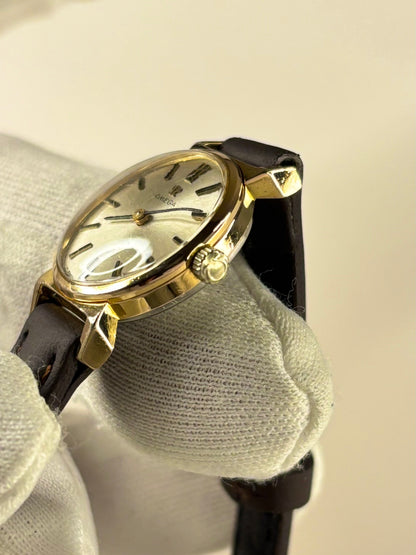 Side profile of Omega ladies Ref. 620 1966 vintage timekeeper with slim gold plated case styling omega signed crown 