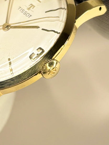 Side profile of Tissot 1967 men’s vintage dress timekeeper with slim gold plated case styling signed crown