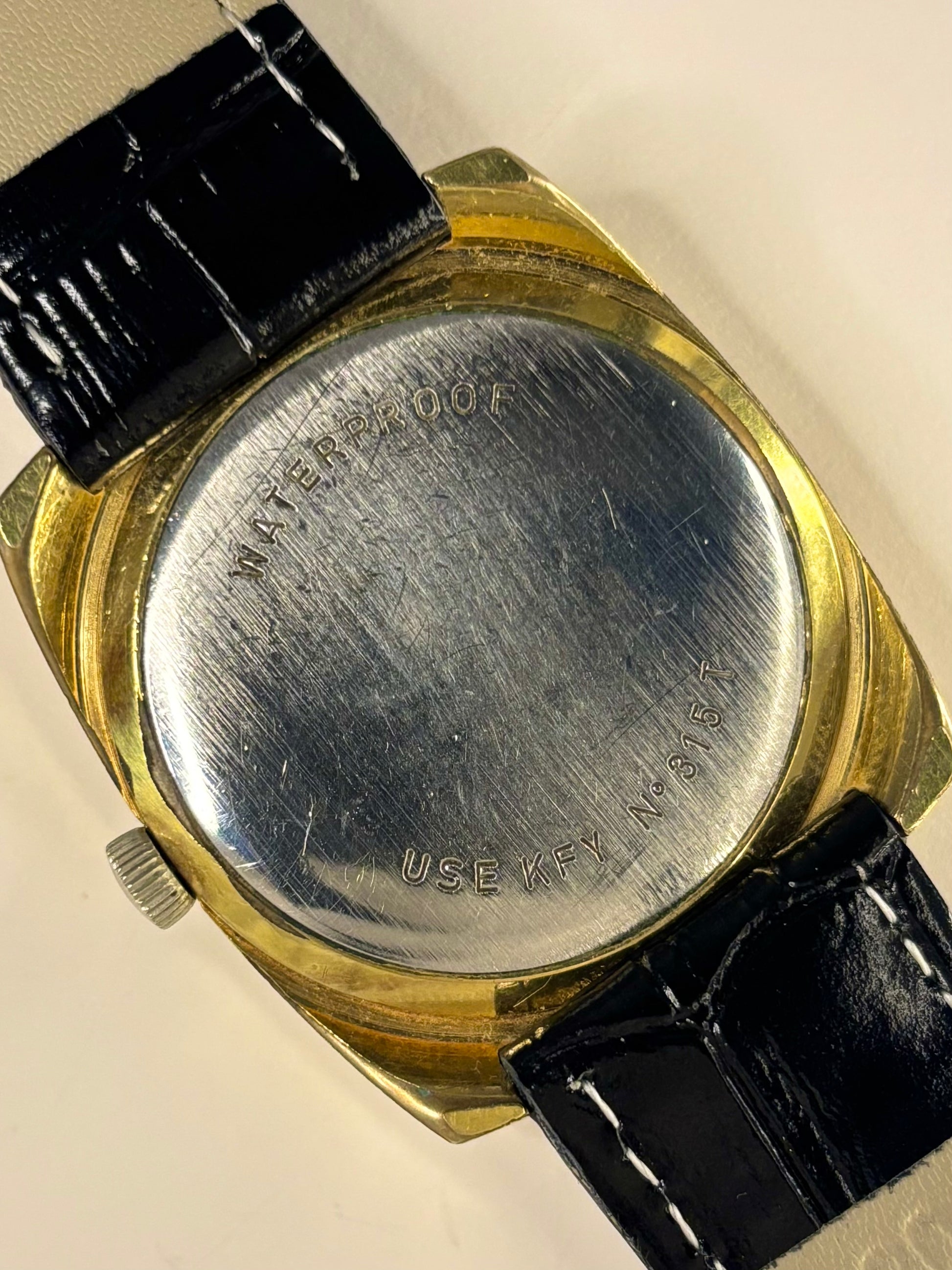 Classic Tissot Seastar Seven manual timepiece, gold sunburst dial and gold-plated case, excellent vintage timekeeper caseback view 