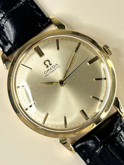 Close-up of Omega 14ct gold vintage men’s watch, automatic movement, sunburst dial