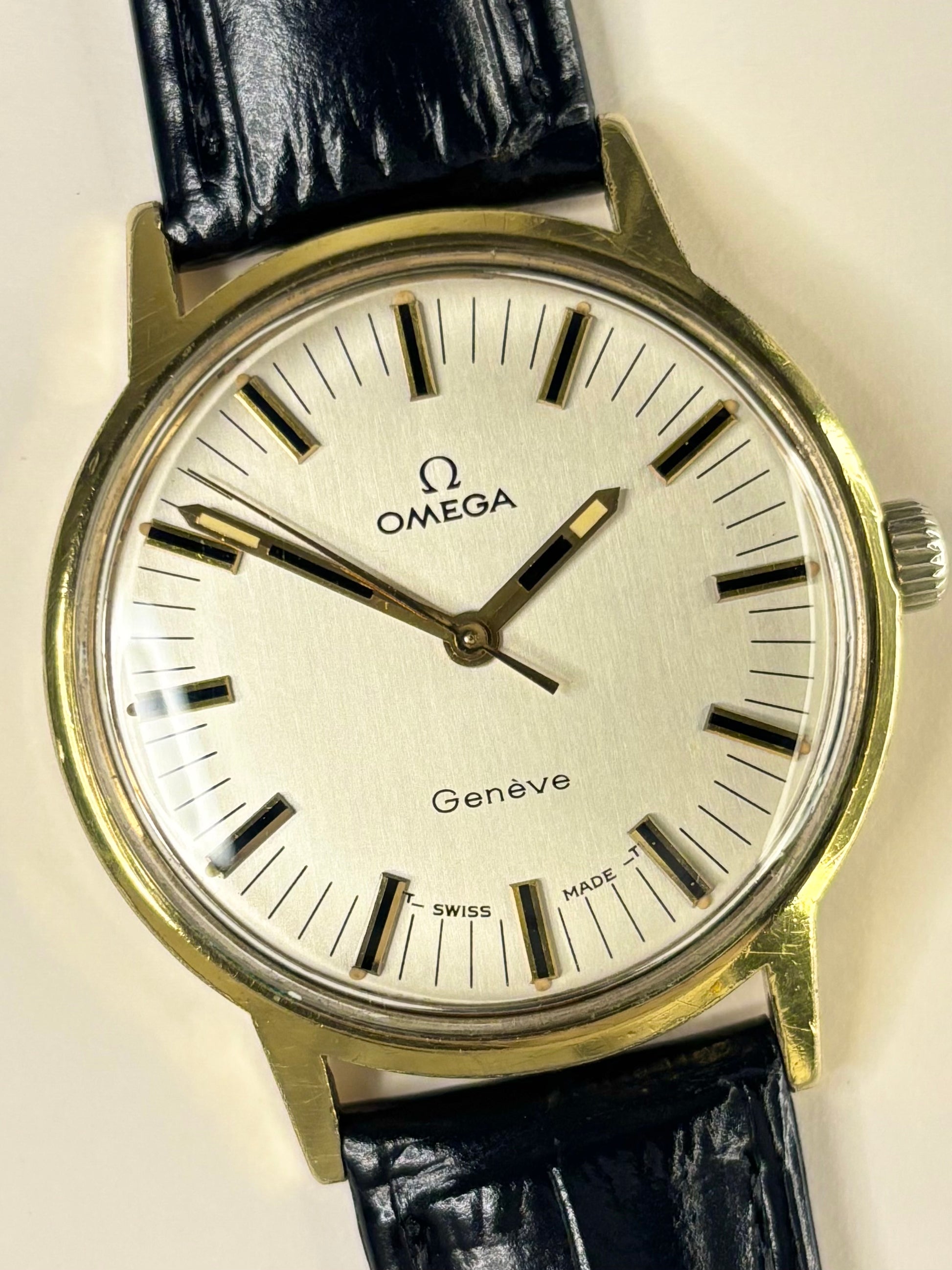 Close-up of Omega Genève vintage manual watch with gold-plated case and original dial, ref. 135.070
