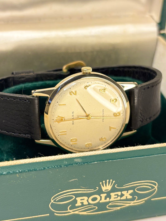 Vintage Rolex Precision timepiece from c.1955, model 12865 with movement 069, featuring a clean dial and 9ct solid gold case, shown as an elegant mid-century timekeeper