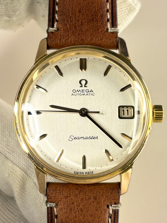 1960s Omega Seamaster automatic watch ref. 166.002 with classic dial and gold-plated case, a timeless Swiss vintage timepiece and refined mechanical timekeeper.