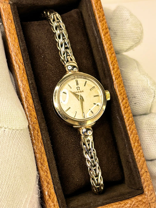 Vintage Omega ref. 77824 watch – c.1956 ladies' solid 9ct gold manual dress watch with integrated gold bracelet, white dial, in good condition with minor age-appropriate marks, weighing 19.16g, complete with original Omega box.