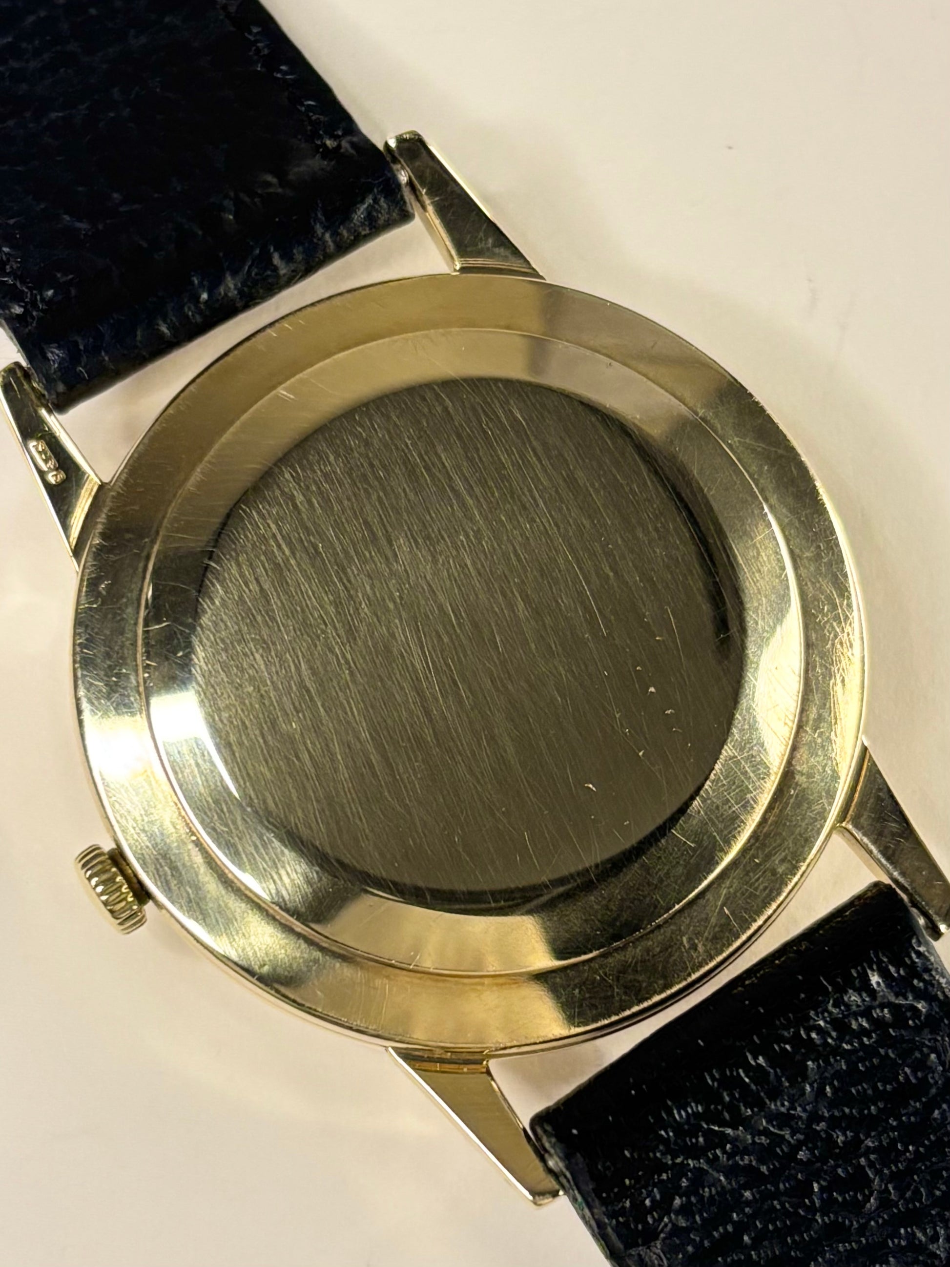 Macro photo of the Rolex Precision timepiece, movement 069 and model 12865, focusing on the textured dial and sharp gold case of this serviced 1950s timekeeper