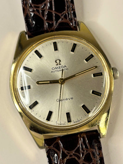 Collectible Omega Genève 1967 gold plated men’s dress timekeeper featuring white sunburst dial and classic style