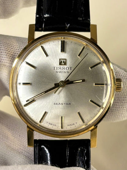 Collectible Tissot Seastar 1986 men’s vintage timekeeper featuring white sunburst dial, manual movement and original box