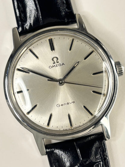 Close-up of Omega Genève vintage manual watch with sunburst dial and stainless steel case, ref. 166.0169