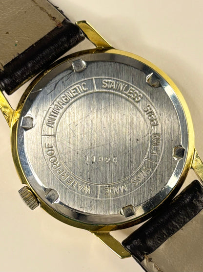Close-up of Avia Cadet vintage men’s dress watch with gold-plated case and manual movement