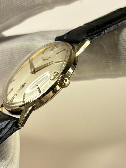 Side profile of Longines 1966 men’s dress timekeeper solid gold manual watch signed crown