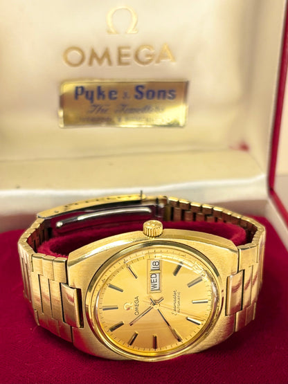 Omega Seamaster men’s timepiece model 166.0216 with gold sunburst dial and gold-plated case, powered by calibre 1022 automatic timekeeper