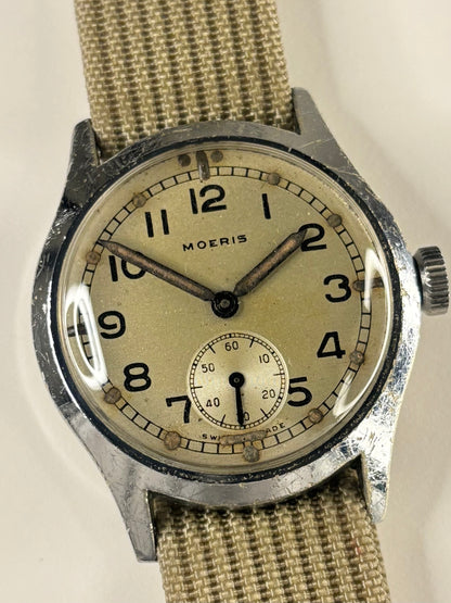 Close up of Moeris 1940s WWII men’s military watch stainless steel dial