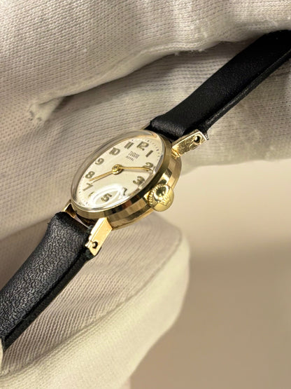 Side profile of Tudor Royal 1958 ladies vintage timekeeper with slim 9ct gold case styling Rolex signed crown