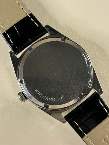 Omega Genève Ref. 136.041 men’s stainless steel dress timekeeper caseback view with hallmark and model details