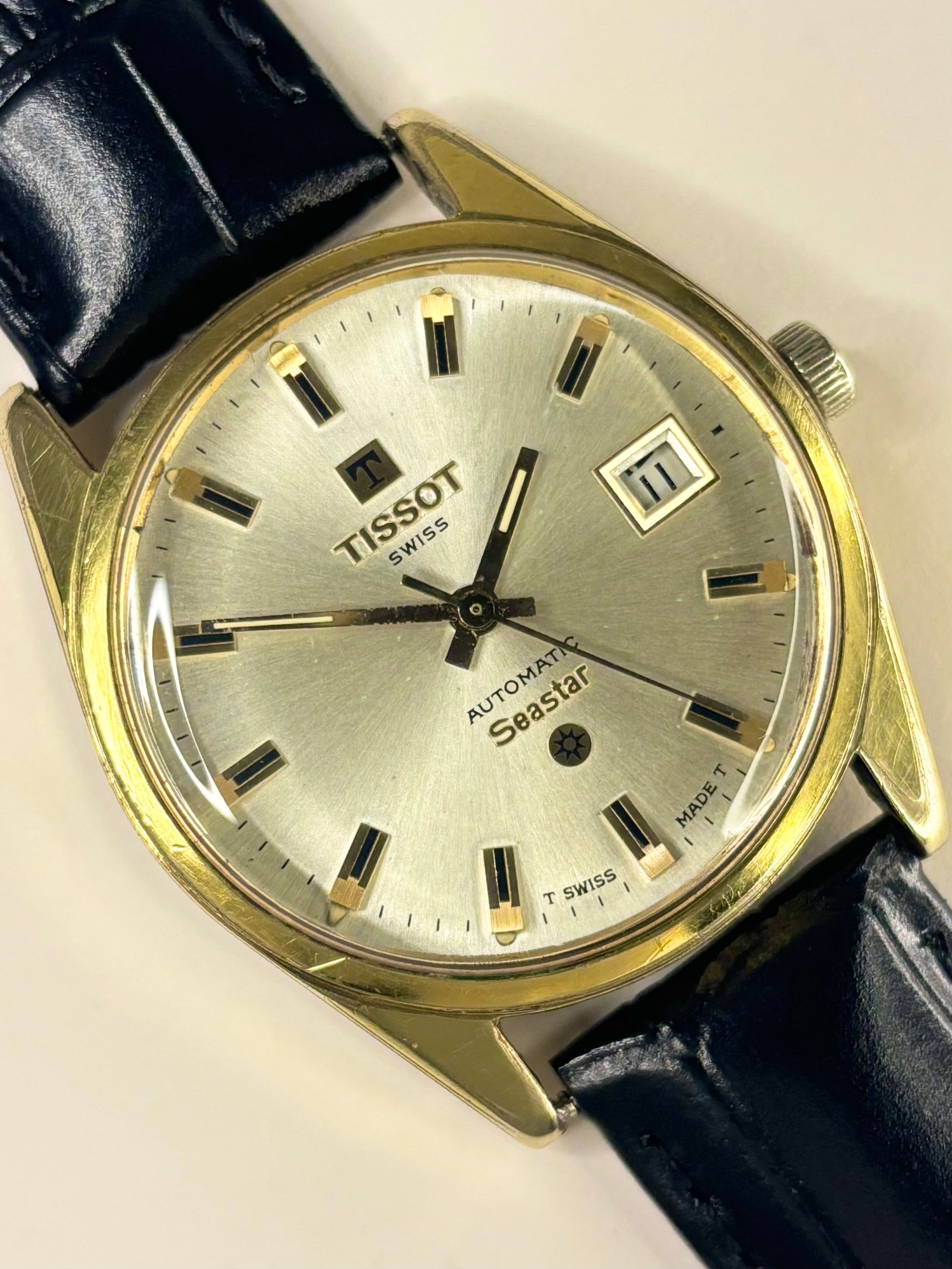 1970s Tissot automatic dress watch with white sunburst dial and gold-plated case, a classic Swiss vintage timepiece and refined mechanical timekeeper.