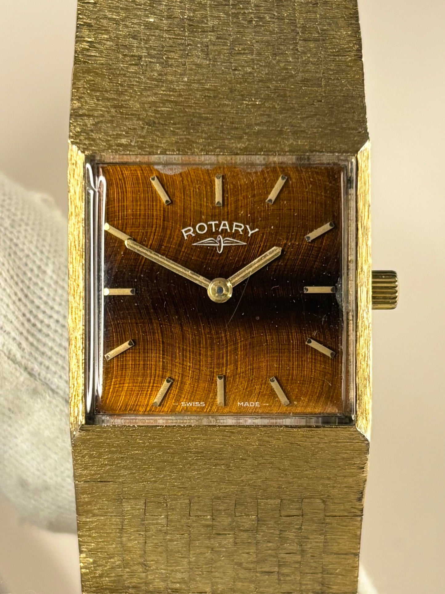 Close-up of the Rotary c.1974 timepiece showcasing its unique tiger’s eye dial and warm gold-plated case, photographed as an elegant manual timekeeper