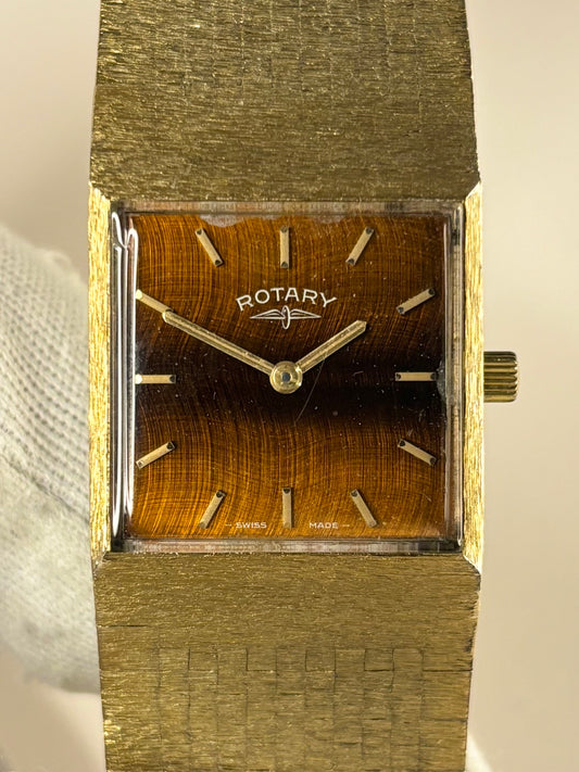 Close-up of the Rotary c.1974 timepiece showcasing its unique tiger’s eye dial and warm gold-plated case, photographed as an elegant manual timekeeper