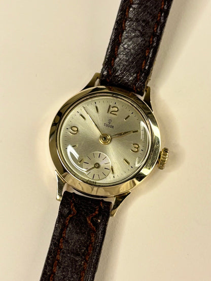 Collectible Tudor 1957 ladies vintage timekeeper featuring white sunburst dial and 9ct gold case
