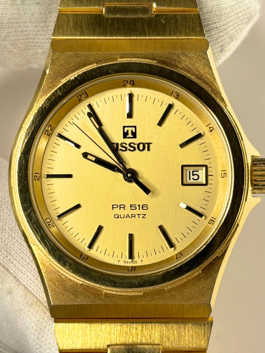 1982 Tissot PR516 men’s timepiece with gold-toned dial and gold-plated case, shown in excellent condition as a classic vintage timekeeper.