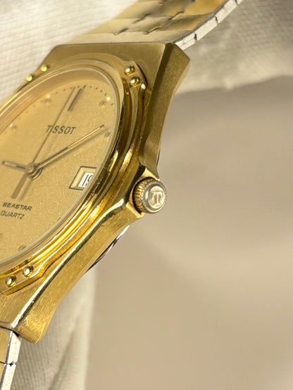Side profile of Tissot 1984 men’s vintage dress timekeeper with slim gold plated case styling Tissot signed crown