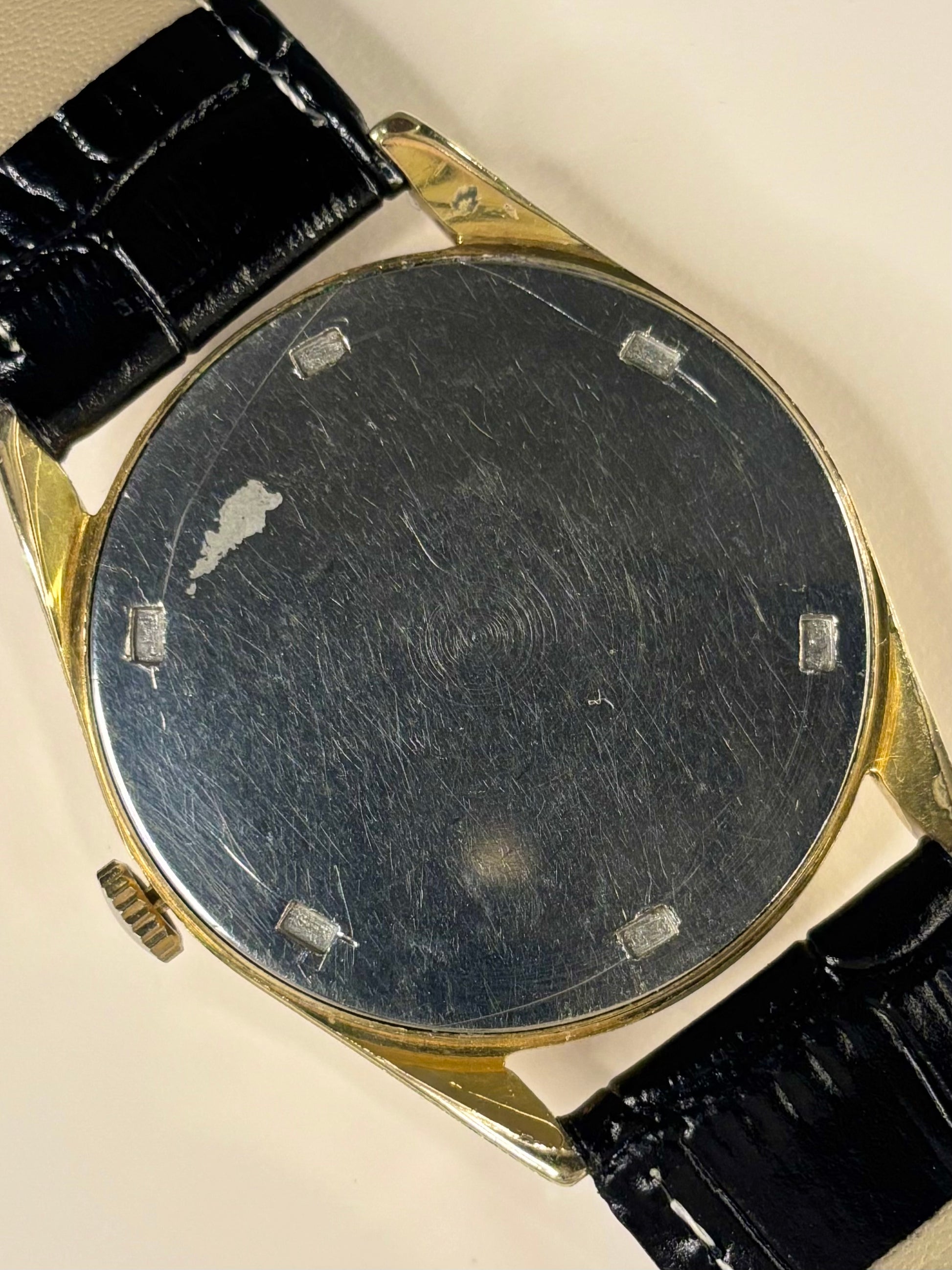 Tissot men’s gold dress watch vintage 1960s manual winding Swiss watch caseback view