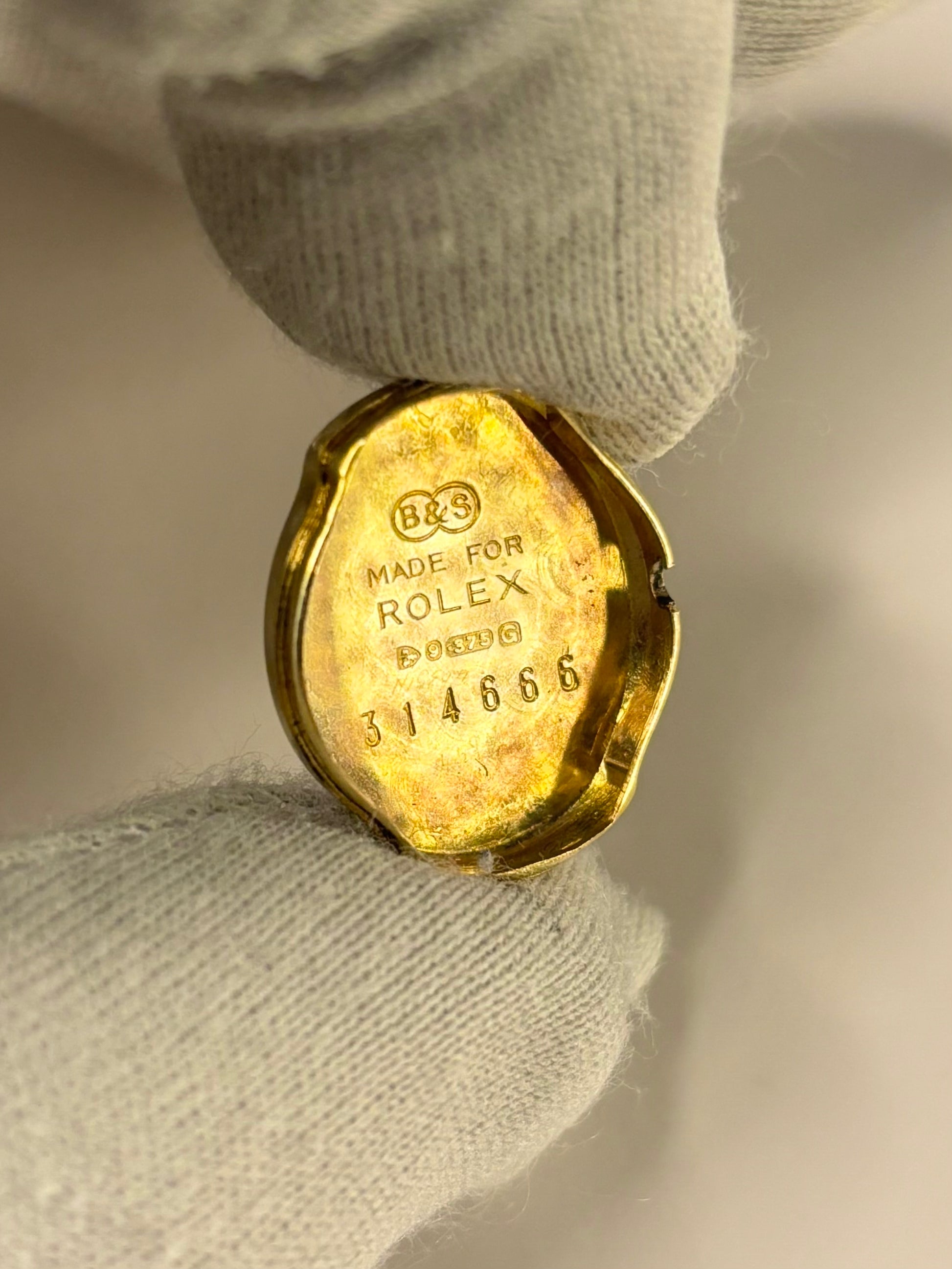 Close-up of Rolex 9ct gold ladies watch Precision manual movement 1950s caseback view 