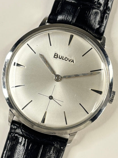 Close up of Bulova 1960s vintage men’s white dial stainless steel watch