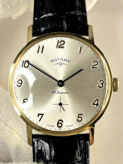 Front-facing view of the Rotary vintage timepiece with gold-plated case and clean white sunburst dial, displayed as a stylish 1970s timekeeper