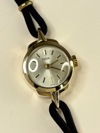 Collectible Tudor 1957 ladies vintage timekeeper featuring white sunburst dial and 9ct gold case
